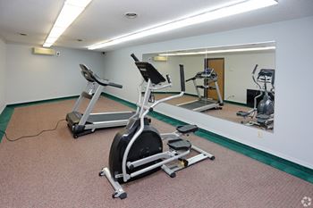 a treadmill and exercise equipment in the fitness room  at Ridgewood Apartments, Grand Forks